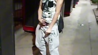 Young exhibitionist pulls out his hard cock and shows off to his friend in the middle off the street as people pass by--strokes, no cum