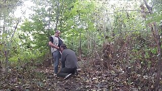 Younger dude gives blowjob to a daddy in the woods