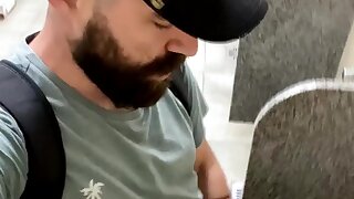 Bearded wanker at urinal