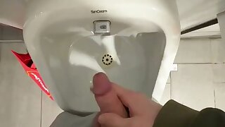 Jerking at the urinal.