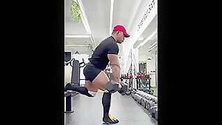 Asian bodybuilder in tight shorts and knee high socks