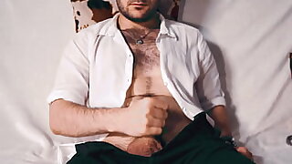 Handsome Noel Dero watches porn and caresses his dick in a condom close-up&period;