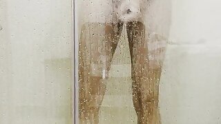 A shy guy jerks in a steamy shower enclosure