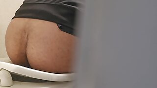 Spying latino in stall