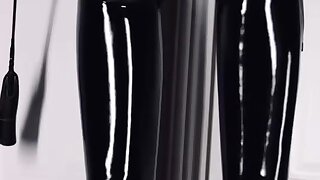 Leather Gay Master showing off his shiny boots