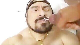 Bearded macho gets a load on his face
