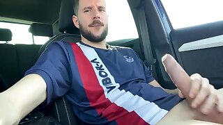 Spanish guy jerks off his uncut cock in his vehicle