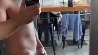 Stocky uncut guy jerking off in front of mirror